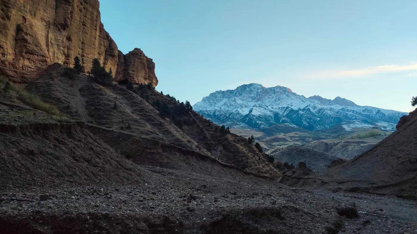 Scenic view of snow-capped mountains and rugged landscape in Osh Region, Kyrgyzstan.