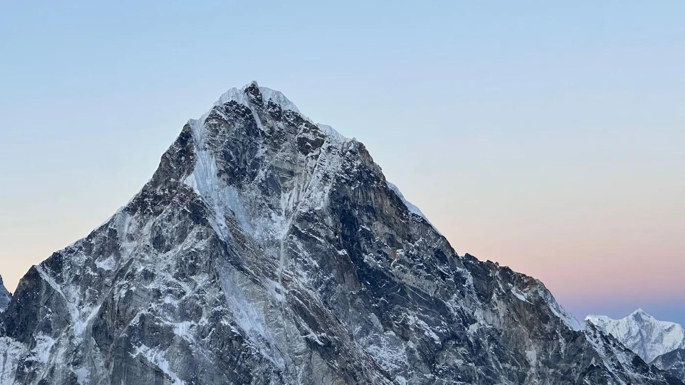 Snow-capped peak in the Himalayas, Nepal, captured during a serene sunset.