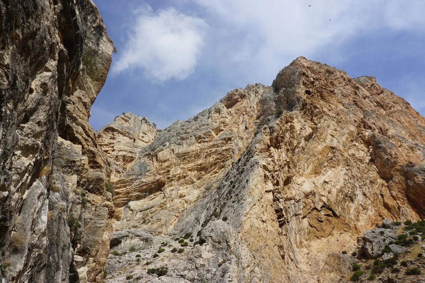 A stunning view of a rocky mountain peak under a clear blue sky, perfect for nature and adventure themes.
