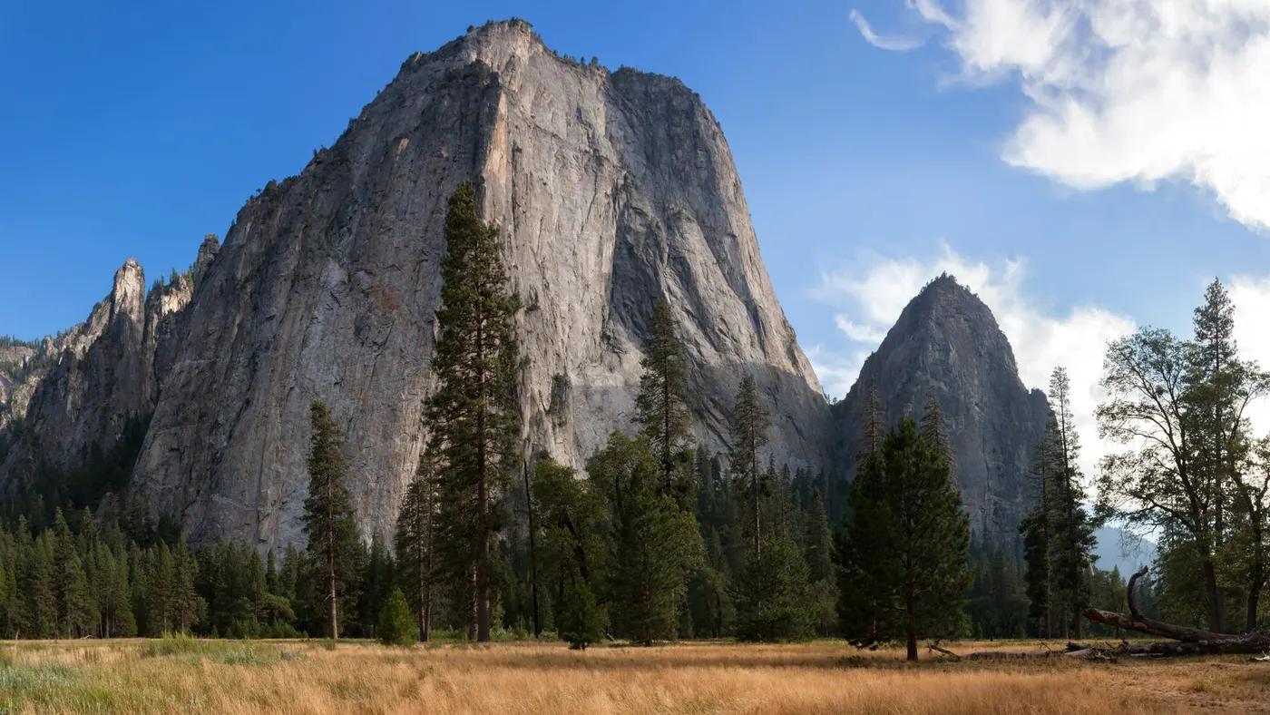 Breathtaking view of rock formations and trees in Yosemite National Park under a clear sky.