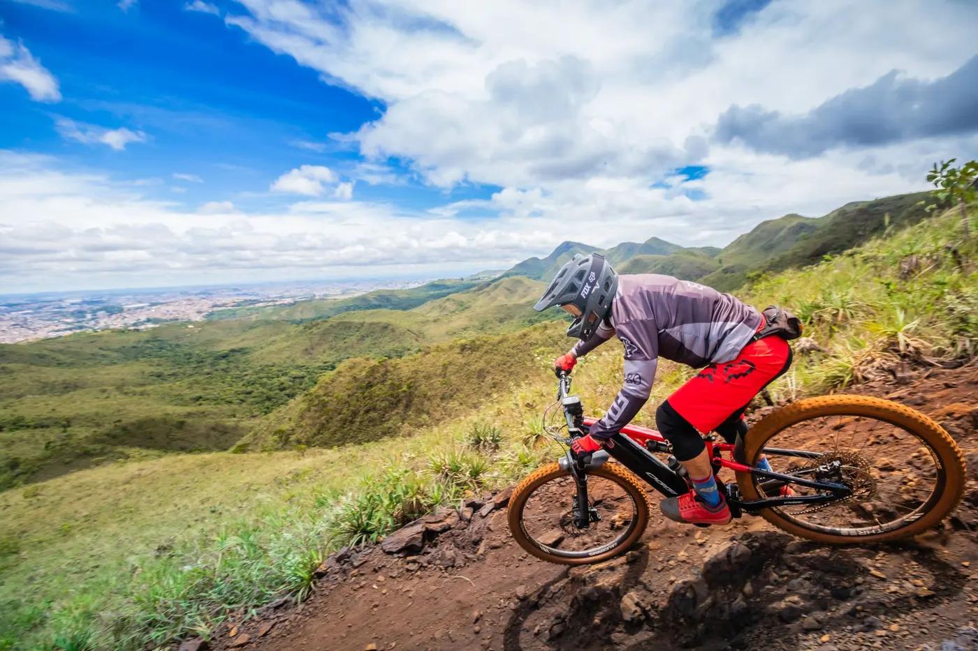 Mountain biker riding through scenic landscape in Minas Gerais, Brazil. Vibrant outdoors adventure.