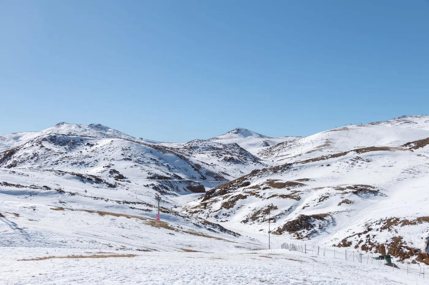 Stunning winter landscape of snow-capped mountains under a clear blue sky in Mavrovo.