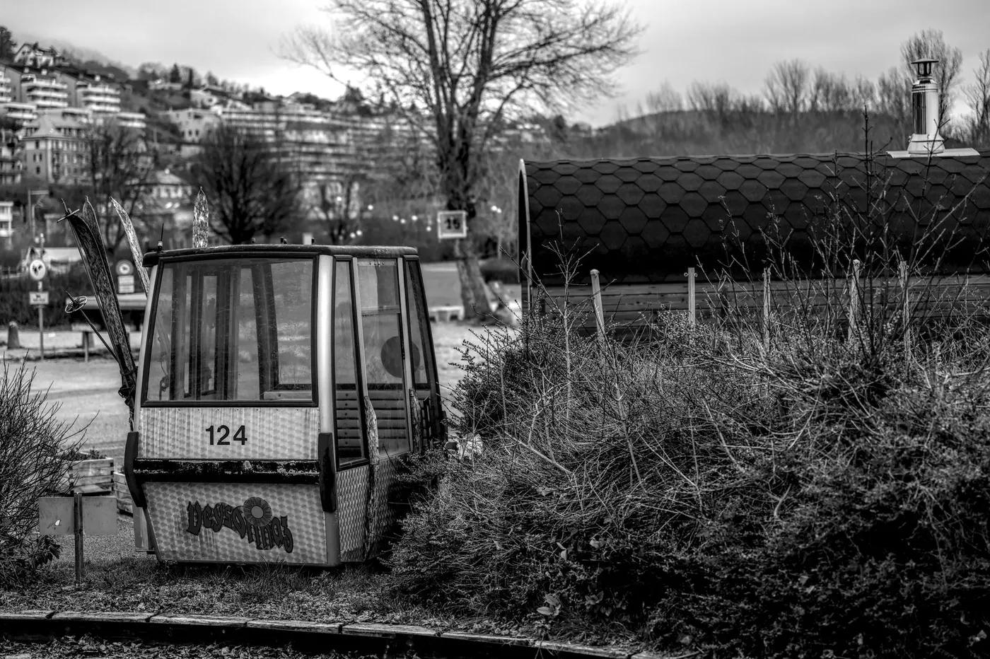 Desolate ski gondola number 124 sits abandoned in a wintry Swiss landscape.