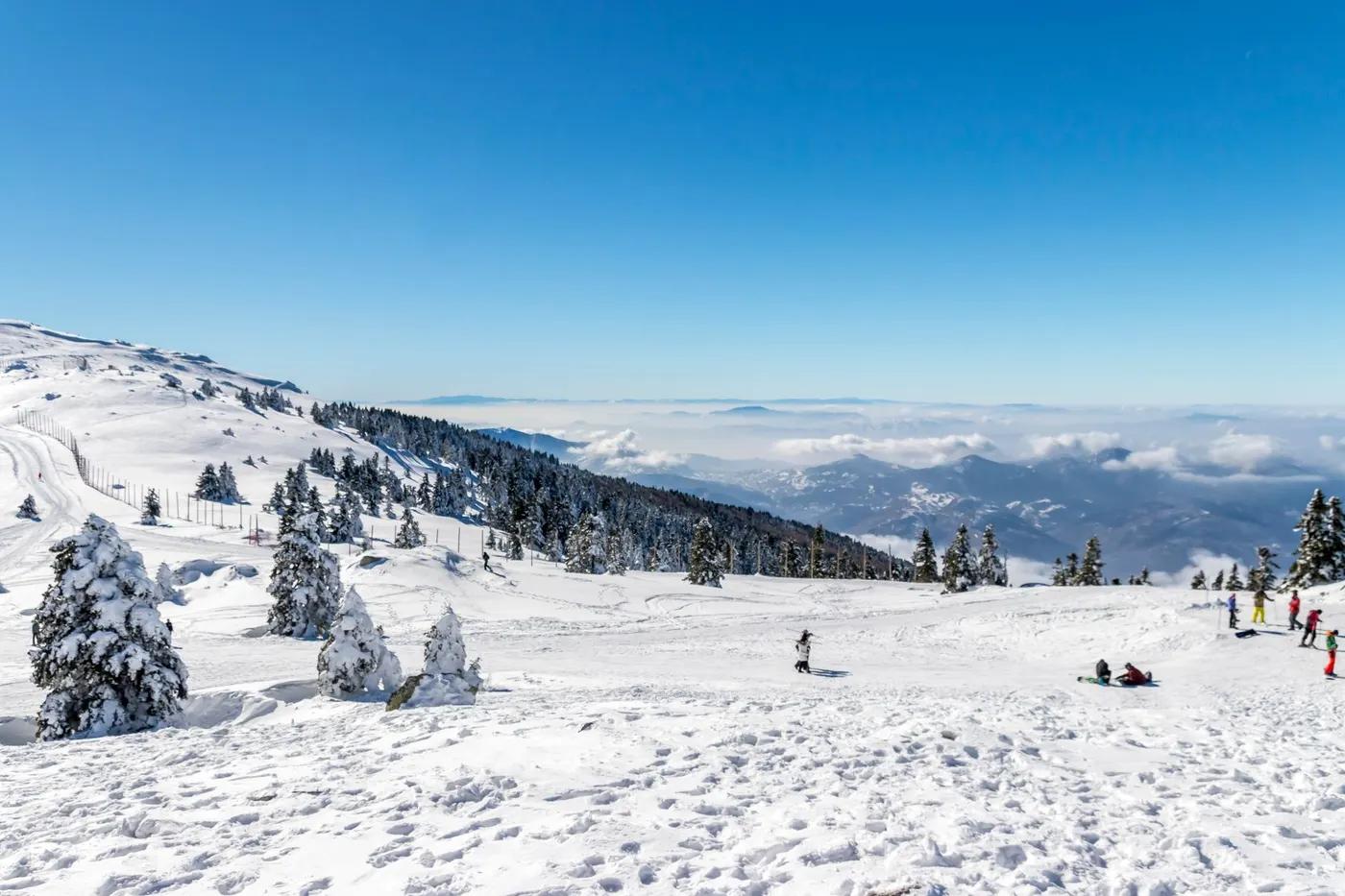 Beautiful winter scene at Uludag Ski Resort with snow-covered mountains and skiers.