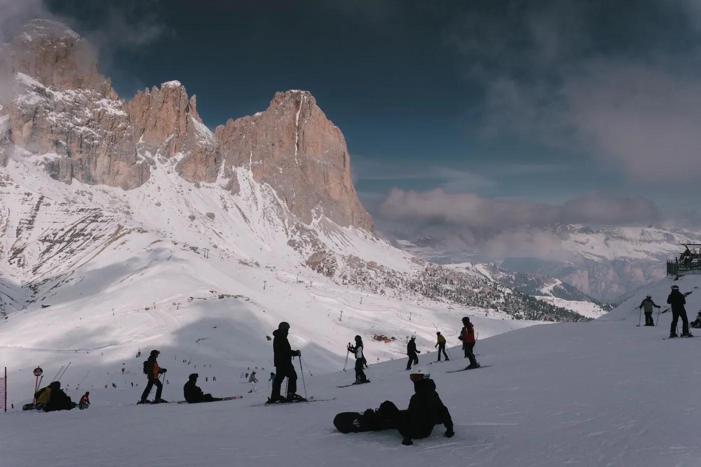 Skiers enjoy a snowy day at the Dolomites in Campitello di Fassa.