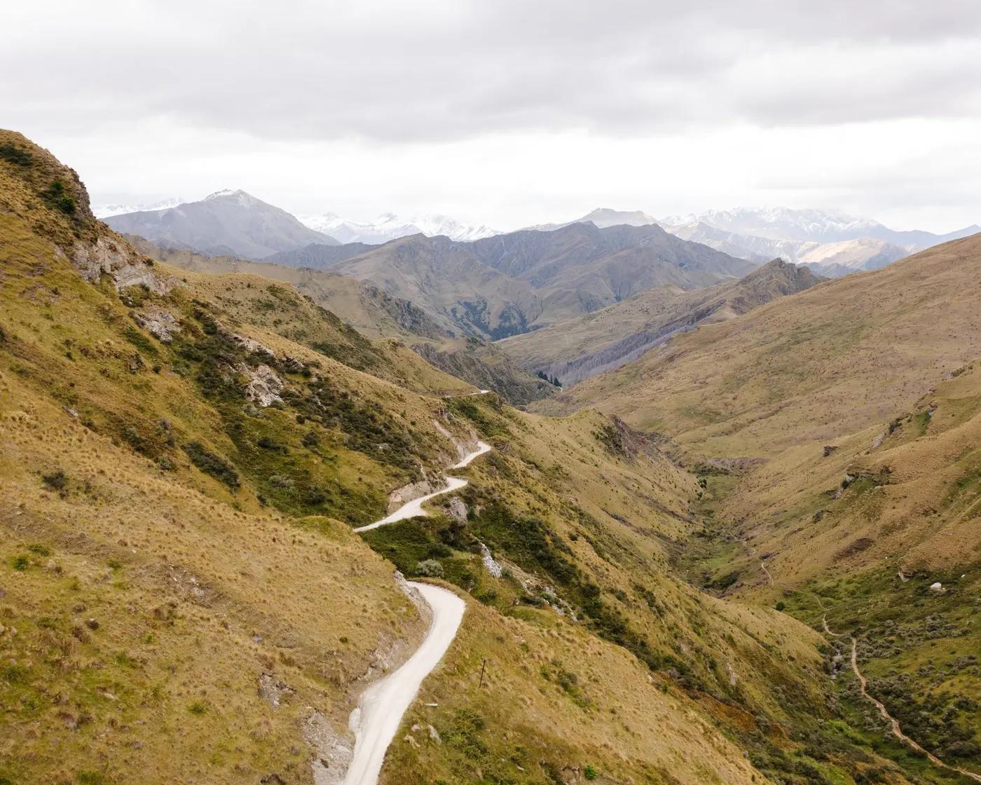 A winding path through the rugged terrain of Coronet Peak in Otago, New Zealand.
