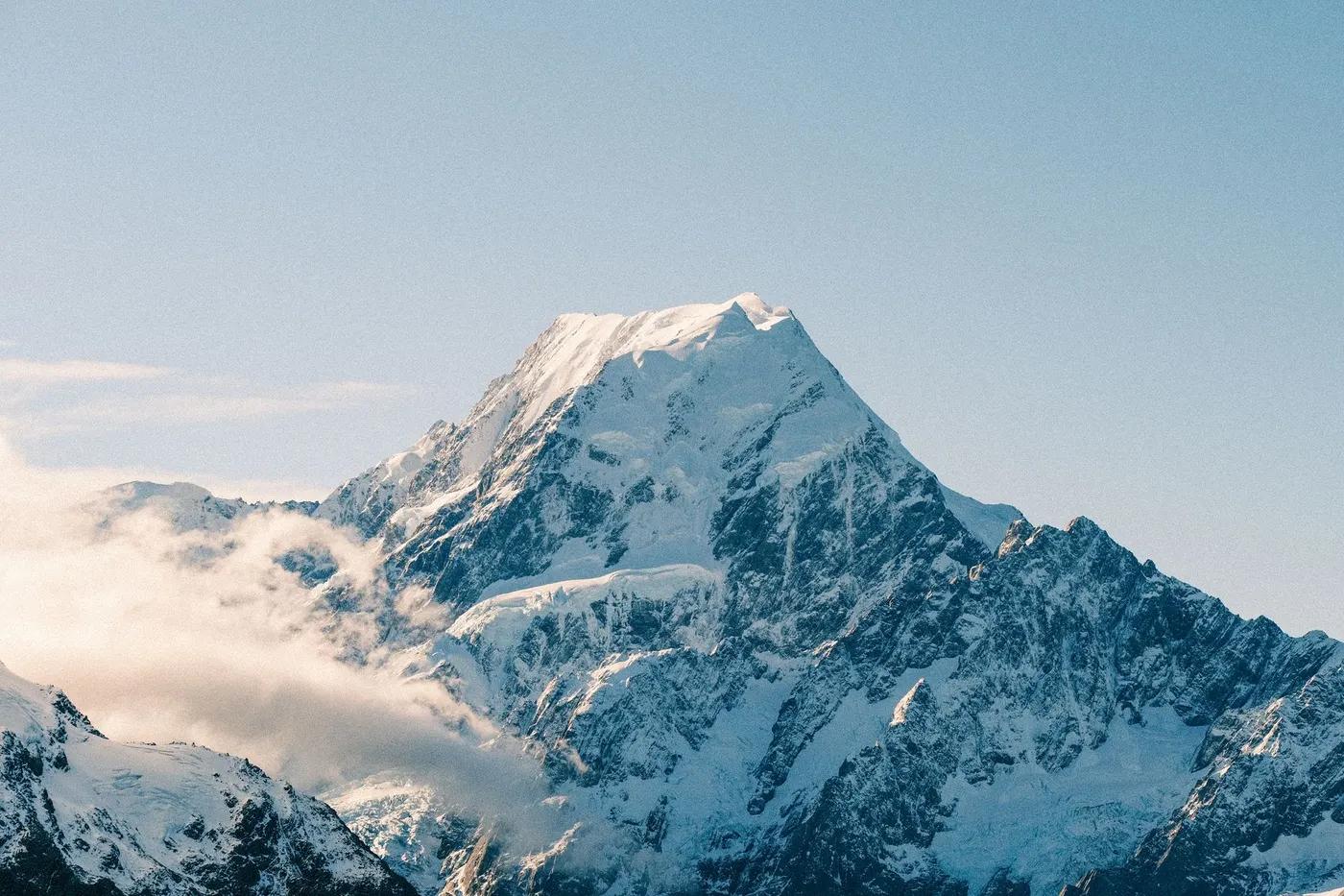 Pristine snow-covered Mount Cook under a clear sky in New Zealand's majestic landscape.
