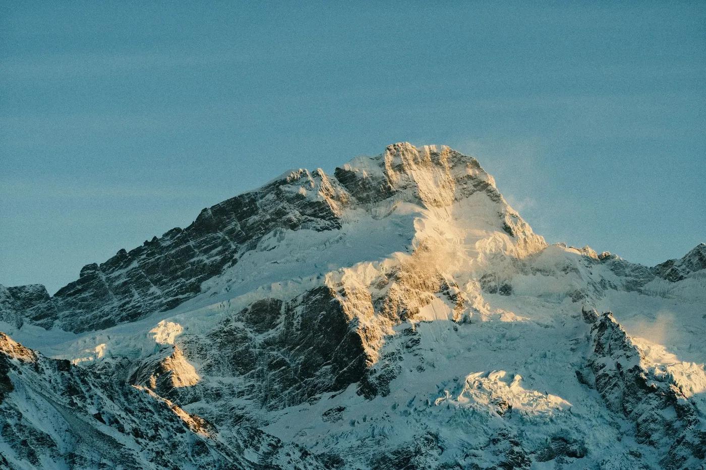 Breathtaking view of a dramatic snow-covered mountain in New Zealand's national park.