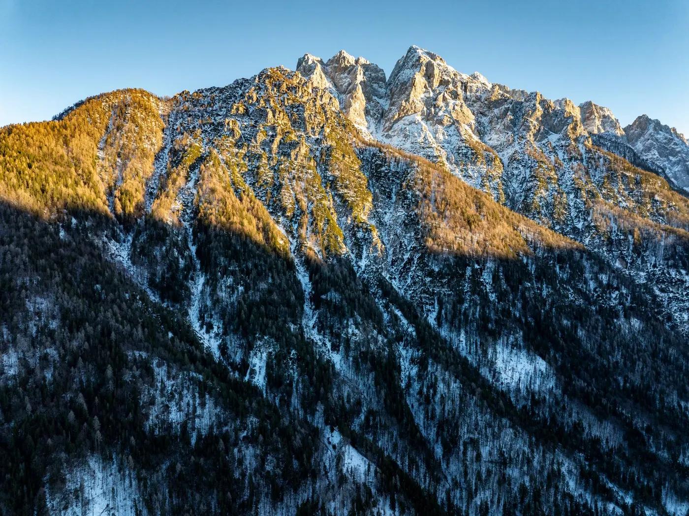 Breathtaking view of snow-covered Julian Alps at sunrise from Kranjska Gora.