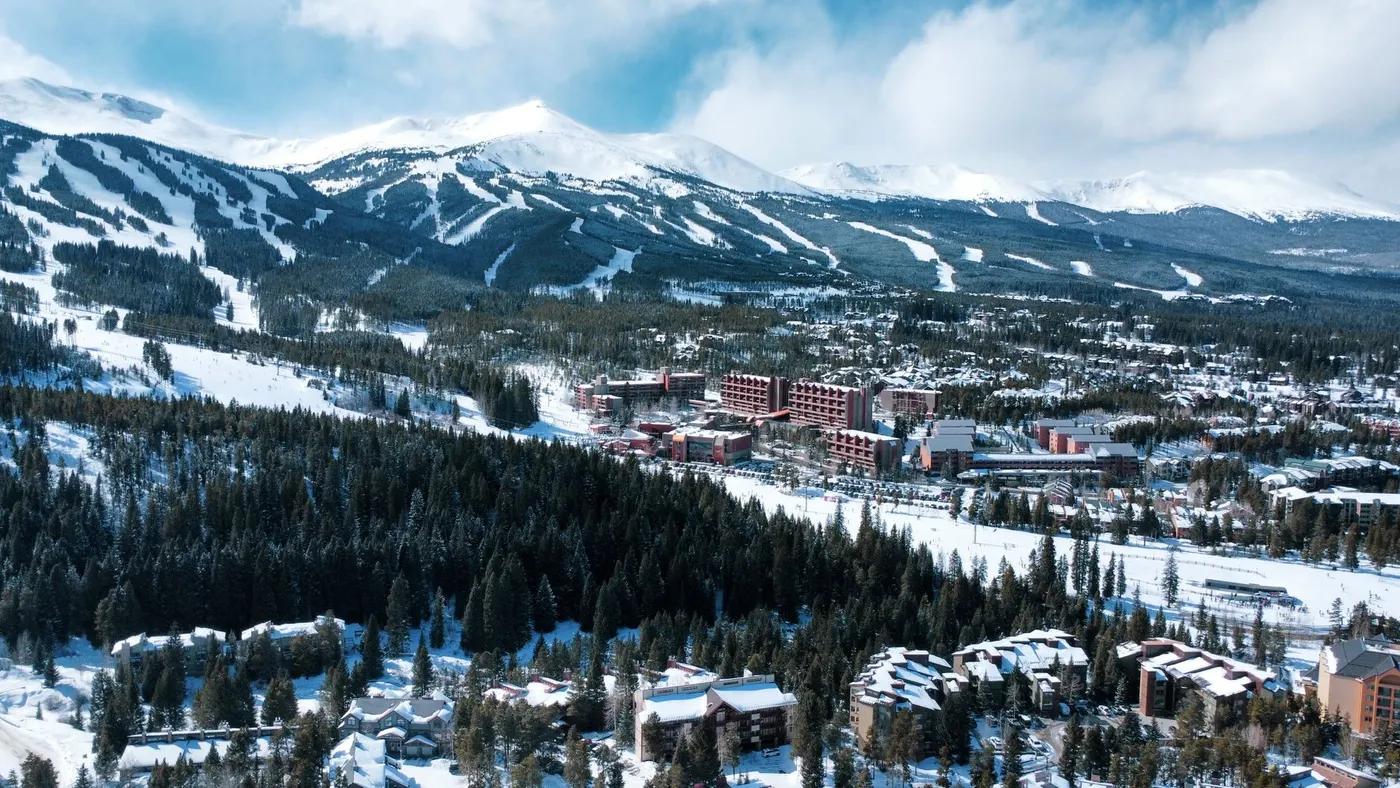 A stunning aerial view of Breckenridge, Colorado, showcasing snow-covered mountains and a winter landscape.