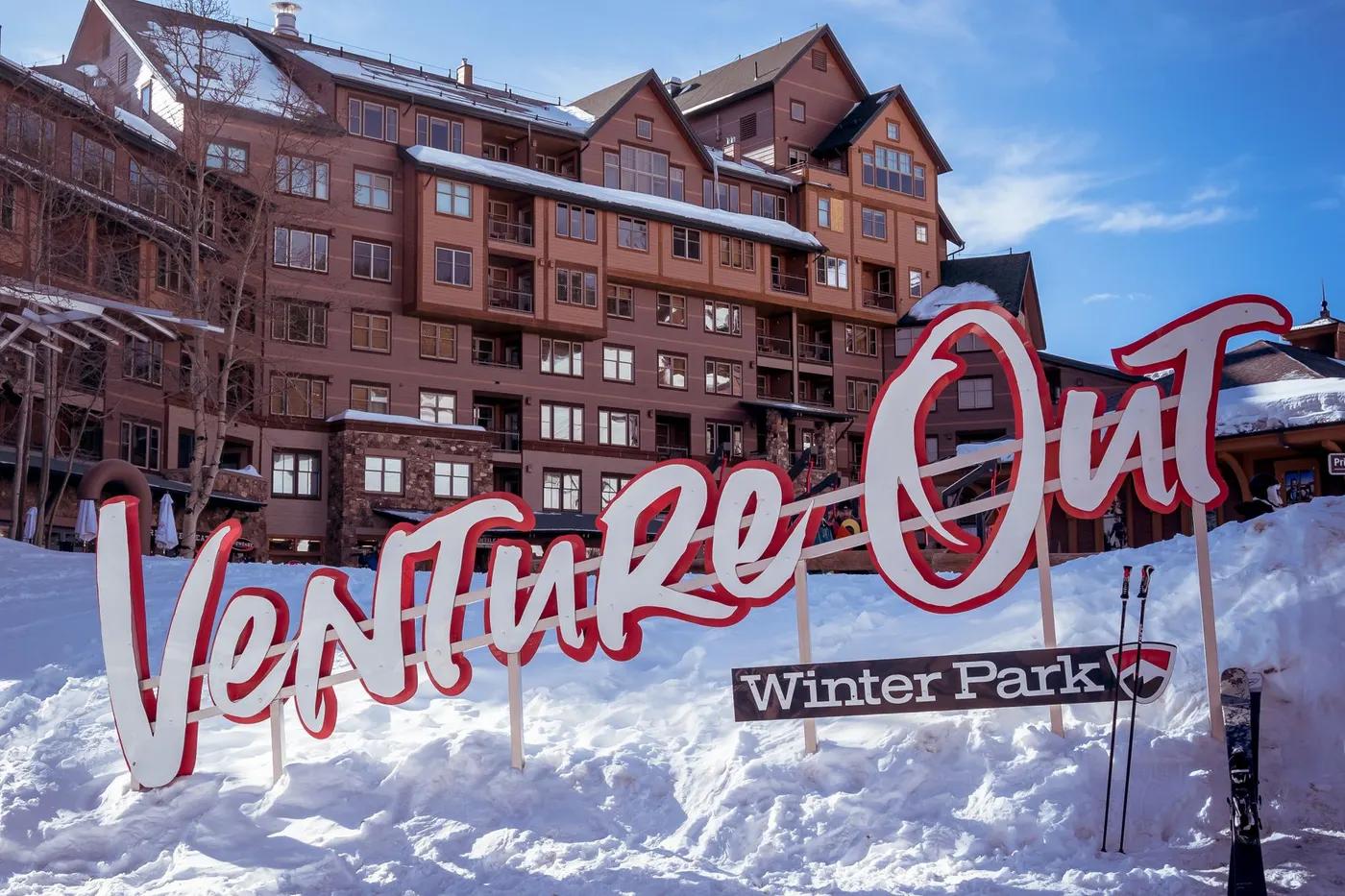 Winter Park ski resort with "Venture Out" sign, perfect winter vacation spot.