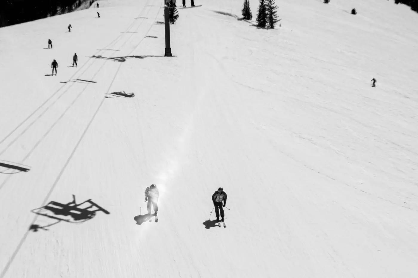 Black and white aerial photo of skiers on a snowy slope in Vail, Colorado. Winter sports enthusiasts enjoying the day.