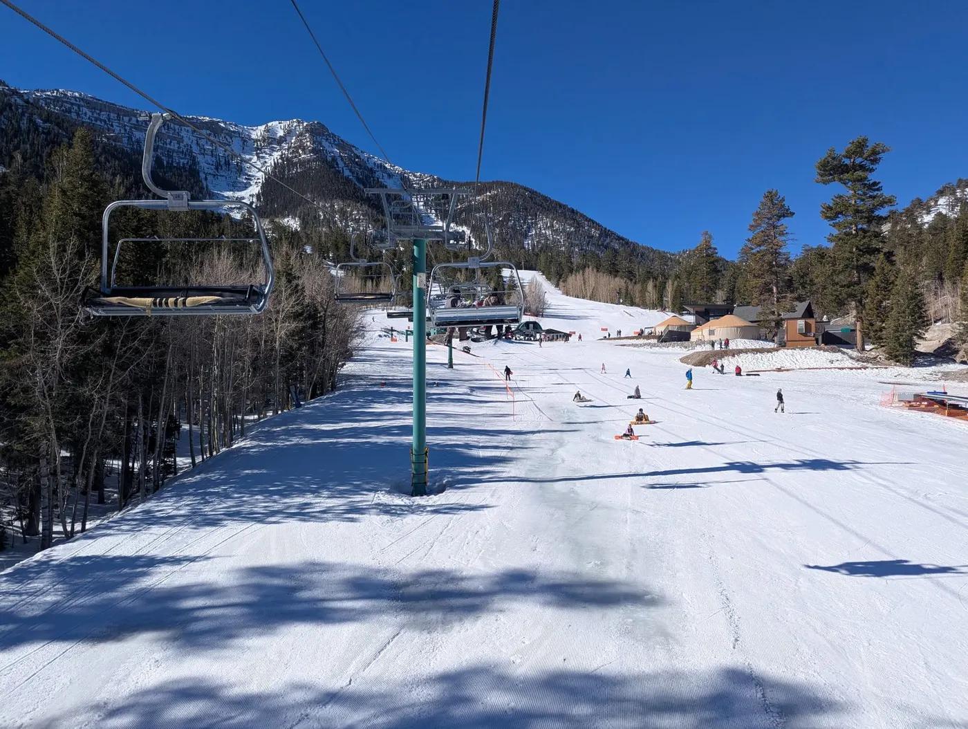 Skiers enjoying a sunny day on snowy slopes at Mount Charleston, Nevada.