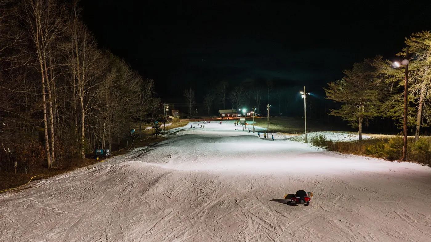 Snowy ski slope at night with lit paths, Cloudmont, Mentone, Alabama.