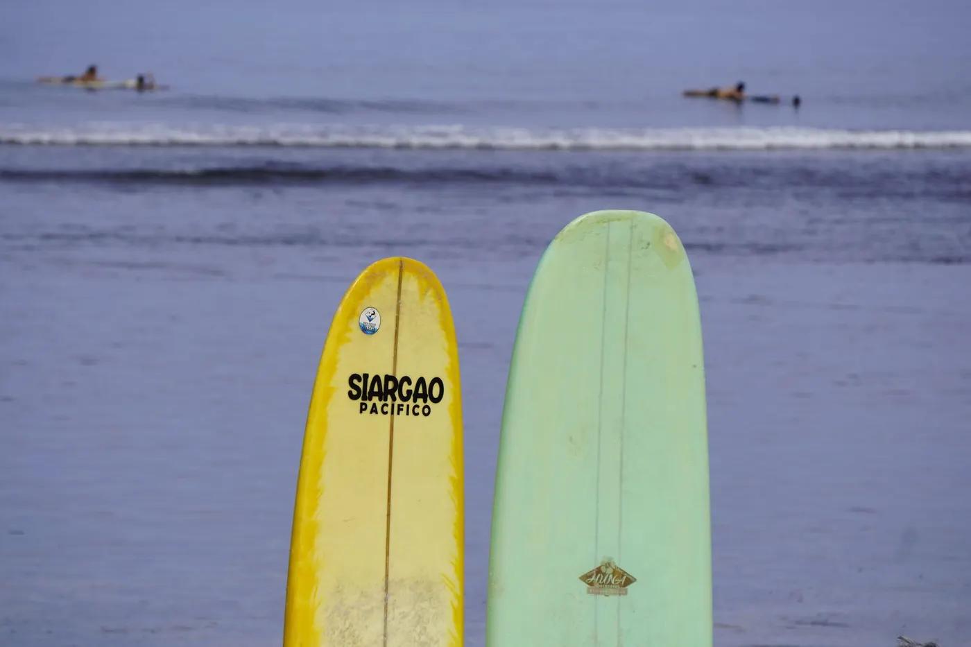 Colorful surfboards on the beach in Siargao, Philippines, a paradise for surfers.