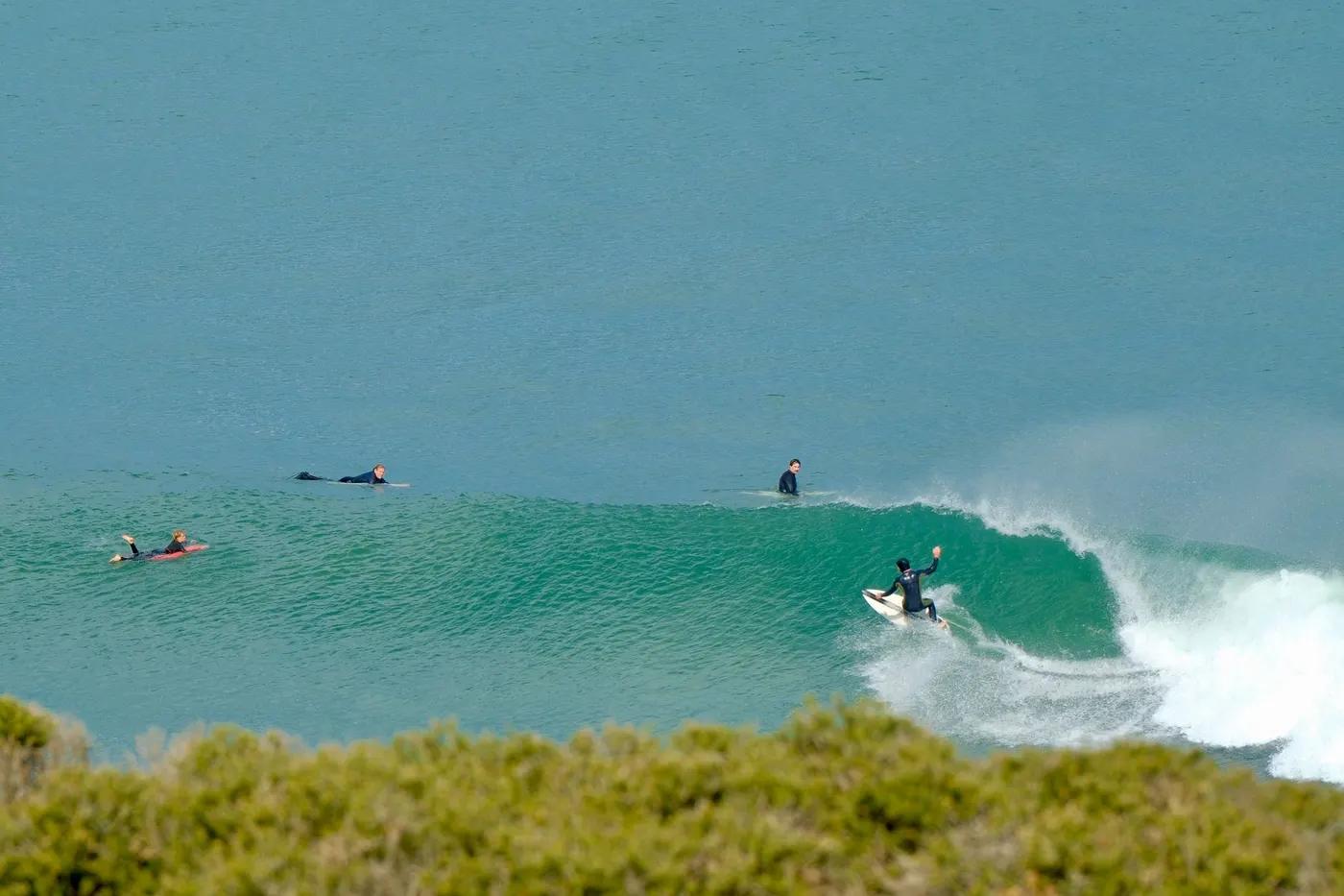 Dynamic surfers riding waves at Bells Beach, VIC, a top Australian surf destination.